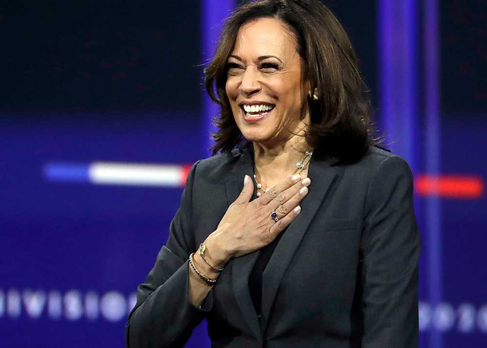 Kamala Harris smiling with her right hand over her heart